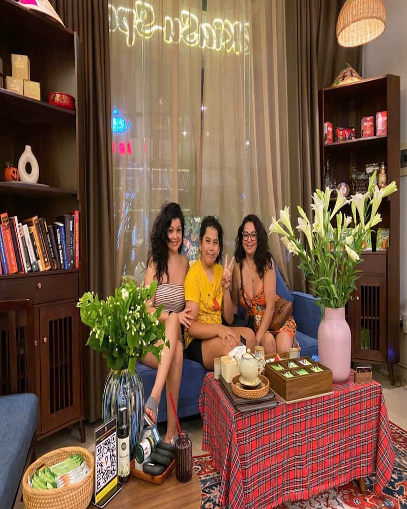 Three happy international female guests relaxing on the sofa at Kiasu Spa.